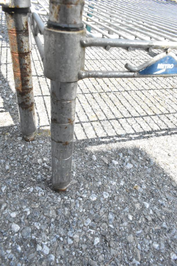 Metro 3-tier chrome wire shelving unit, rust on legs, includes snow shovels, water filter. Buyer must dismantle.