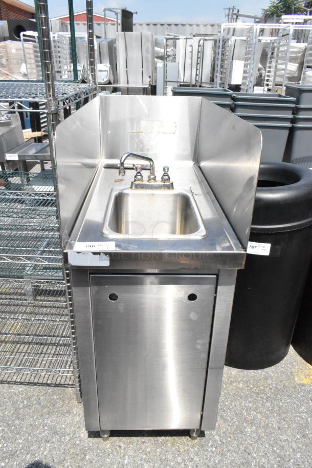 Stainless steel single bay sink with faucet, handles, and side splash guards. Good condition. Ideal for commercial use.