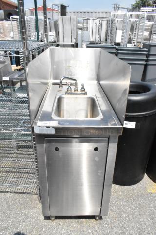 Stainless steel single bay sink with faucet, handles, and side splash guards. Good condition. Ideal for commercial use.