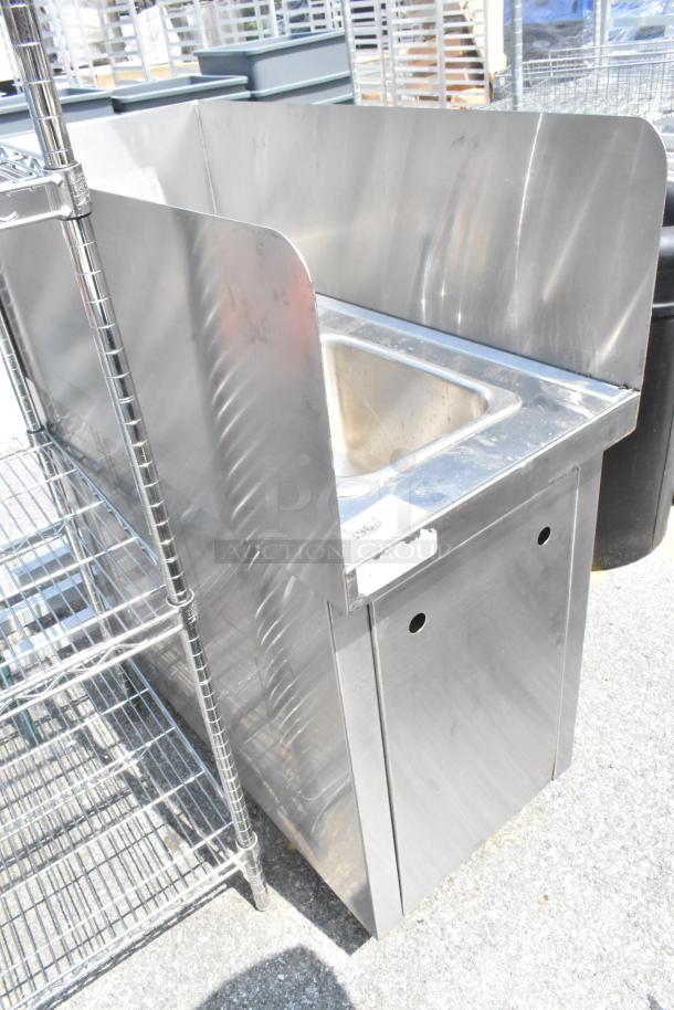 Stainless steel single bay sink with faucet, handles, and side splash guards. Good condition with protective sides.
