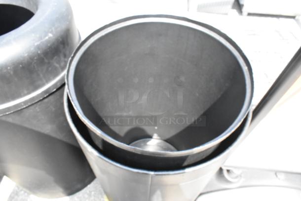 Two black trash can shells, shown stacked. Each shell is cylindrical and appears in good condition. Auction offers two for one bid.