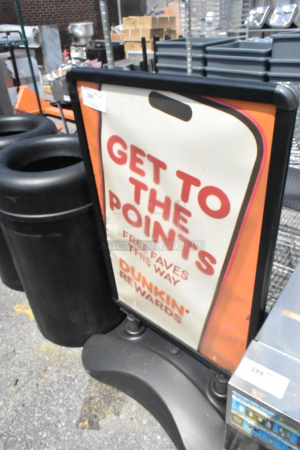 Black sidewalk sign with Dunkin' Rewards ad, promoting points earning. Sturdy plastic frame; suitable for storefronts.