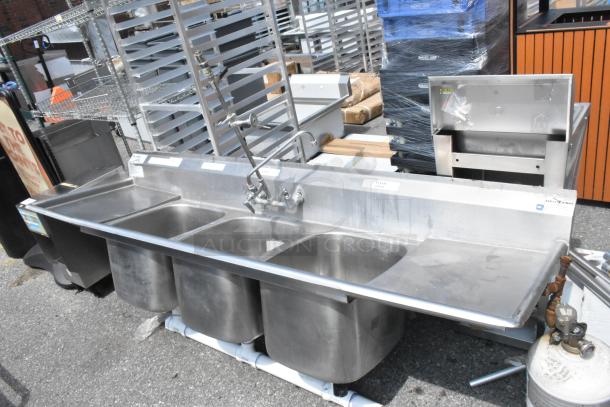 Eagle stainless steel 3-bay sink with dual drain boards, faucet, and handles. No legs. Good condition.