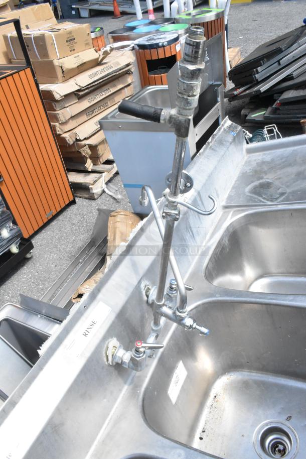 Eagle stainless steel 3-bay sink with dual drain boards, attached faucet, handles, no legs, visible wear.