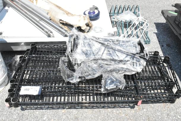 Lot of 8 scratch and dent items including brand new black finish wire shelves. Various parts visible, some wrapped in plastic.