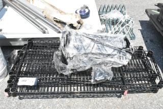 Lot of 8 scratch and dent items including brand new black finish wire shelves. Various parts visible, some wrapped in plastic.