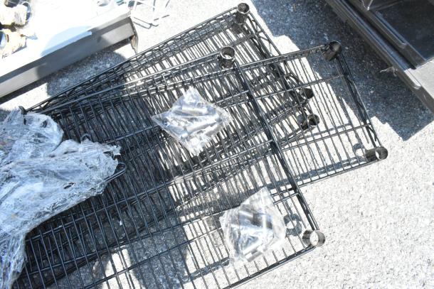 Lot of 8 brand new black finish wire shelves, scratch and dent condition, includes assembly hardware.