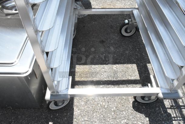 Brand new New Age metal pan transport rack on commercial casters; scratch and dent condition; sturdy metal frame.