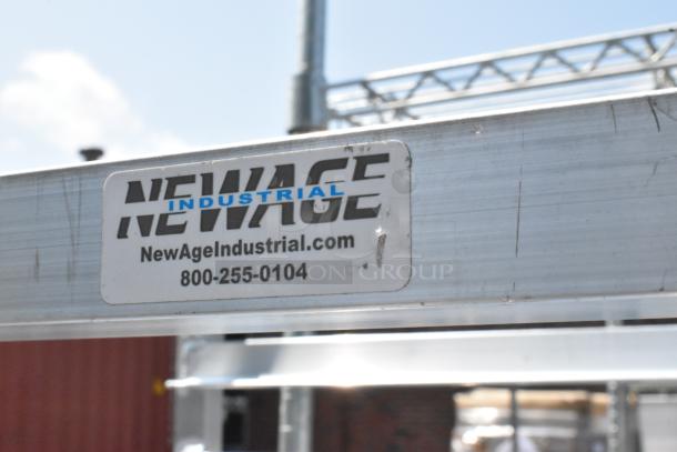 New Age Metal Pan Transport Rack, commercial casters, label shows "NEWAGE INDUSTRIAL" with contact info, scratch and dent condition.