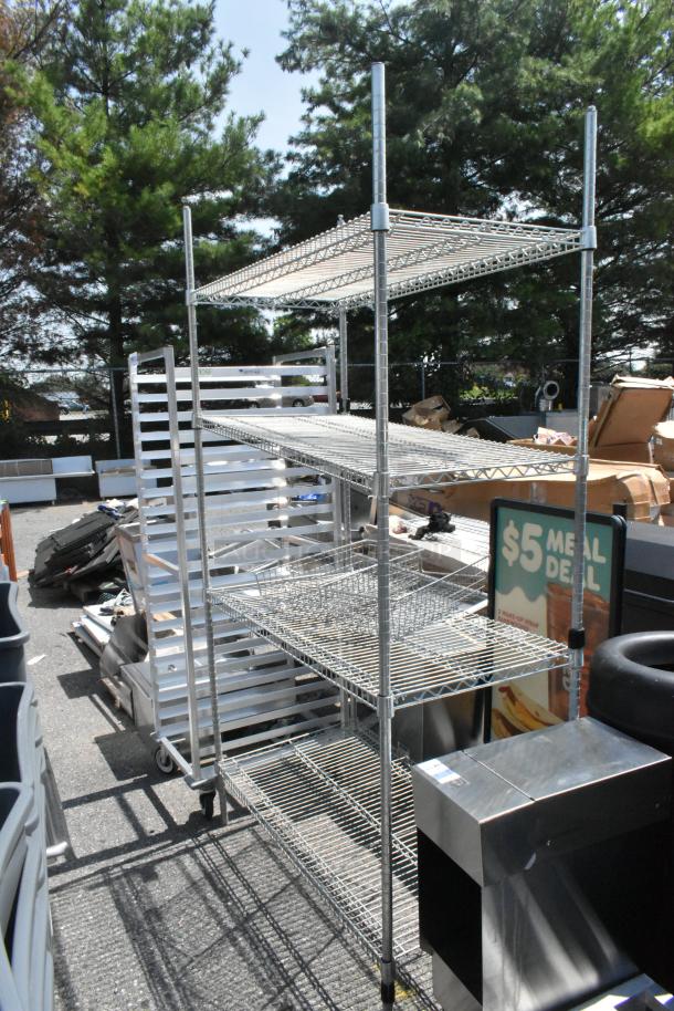 Chrome finish 4-tier wire shelving unit outdoors. Buyer must dismantle. Consider freight charges.