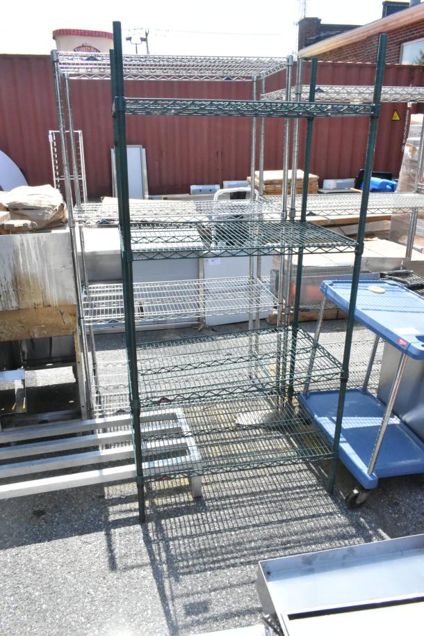 Metro green finish 4-tier wire shelving unit. Metal construction, outdoor setting, buyer must dismantle.