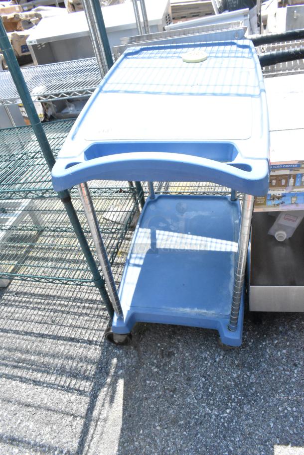 Metro Blue Poly 2-Tier Cart on Commercial Casters, gently used, featuring sturdy plastic shelves and metal supports.