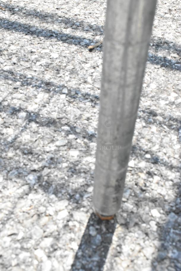 Metro Chrome Finish 3 Tier Wire Shelving Unit leg detail on concrete surface. Buyer must dismantle for shipping.