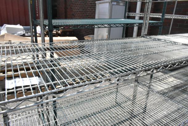 Chrome finish 5-tier wire shelving unit, sturdy design, visible wear, buyer must dismantle, consider freight charges.