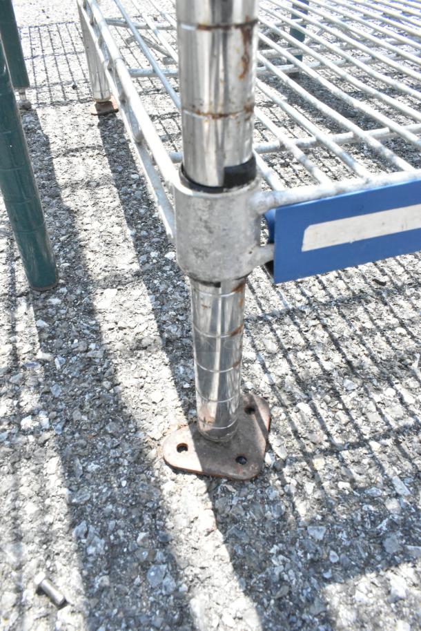 Chrome finish 5 tier wire shelving unit base, showing chrome poles and attached wire shelves. Buyer must dismantle.