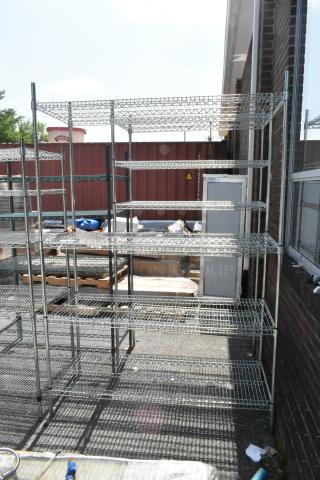 Chrome finish 4-tier wire shelving unit. Outdoor setting. Buyer must dismantle. Consider freight charges.