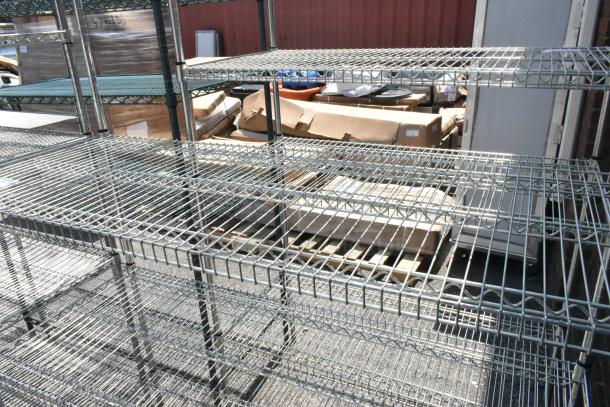 Chrome finish 4-tier wire shelving unit, suitable for storage. Unit must be dismantled by buyer; consider freight charges.