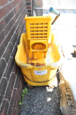 Yellow poly mop bucket with wringing attachment on commercial casters, visible wear, auction tag "419 1".