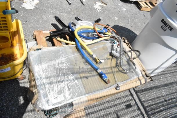 Pallet lot with gas hoses, spray nozzle, and wrapped Regency 24"x48" NSF green epoxy wire shelf, labels visible.