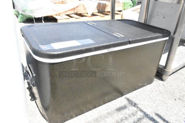 Brand new black bin with center hinge lid, minor scratches, metal handles, outdoor setting. Label reads "A229."