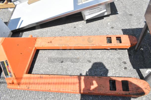 HaulMaster 2.5 Ton Pallet Jack, orange metal, 5,000 lb capacity, visible wear, manufacturer label attached.
