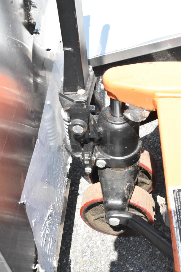 HaulMaster 2.5 Ton Orange Metal Pallet Jack, black wheels, 5,000 lb capacity shown in used condition.
