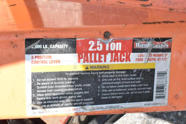 HaulMaster 2.5 Ton Orange Metal Pallet Jack, 5,000 lb capacity, with 3-position control lever and safety warnings.