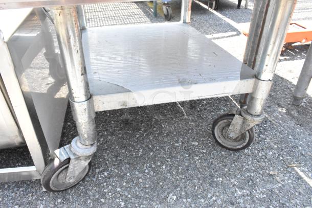 PrepLine PES-3024 stainless steel equipment stand with metal under shelf, on commercial casters. Visible wear on surface.