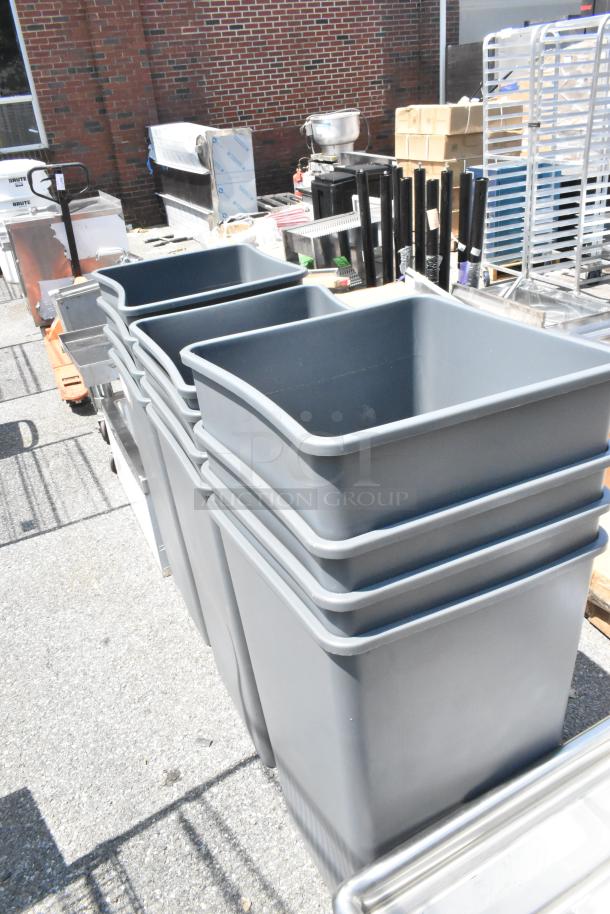 Brand new gray poly trash cans, scratch and dent condition, stack of 12, durable material, ideal for bulk purchase.