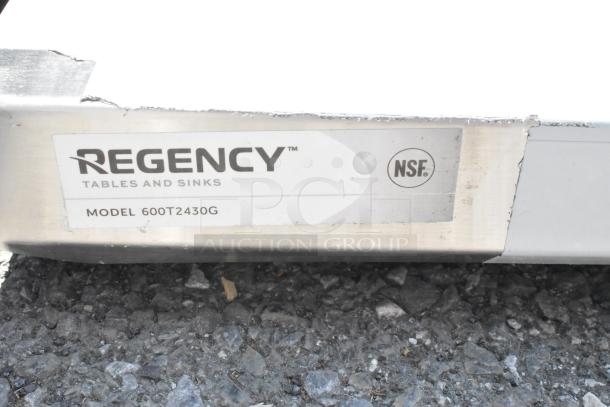 BRAND NEW SCRATCH AND DENT! Regency 600T2430G work table label showing model and NSF certification; 304 stainless steel.