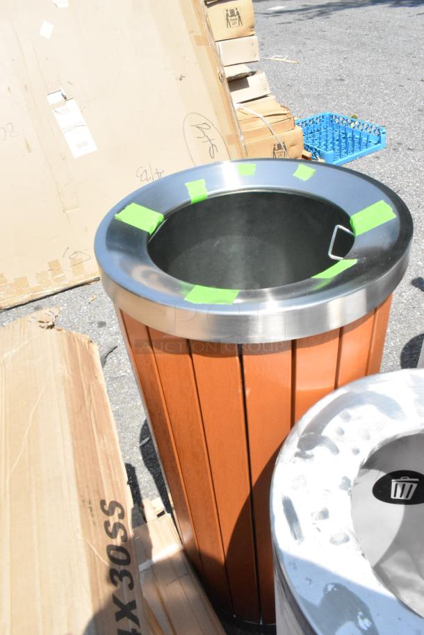 Brand new Lancaster Table & Seating metal and wood trash can shell with minor scratches, cardboard packaging visible.