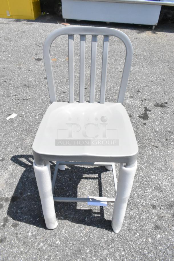 Brand new metal bar height chair, model CHA20250110. Light grey, slatted back, minimal scratch and dent marks.