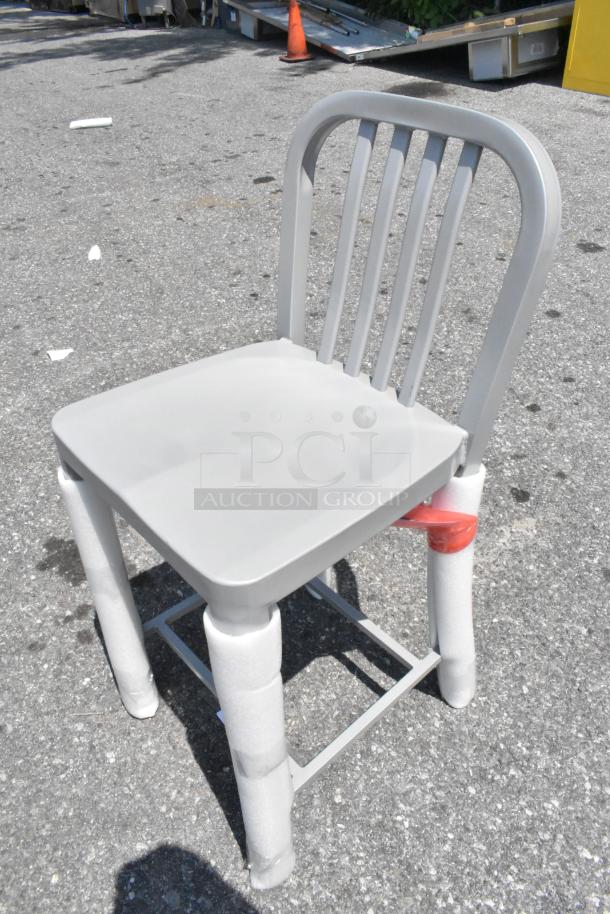 Brand new metal bar height chair, model CHA20250110, with scratch and dent marks. Beige finish, protective wrapping on legs.
