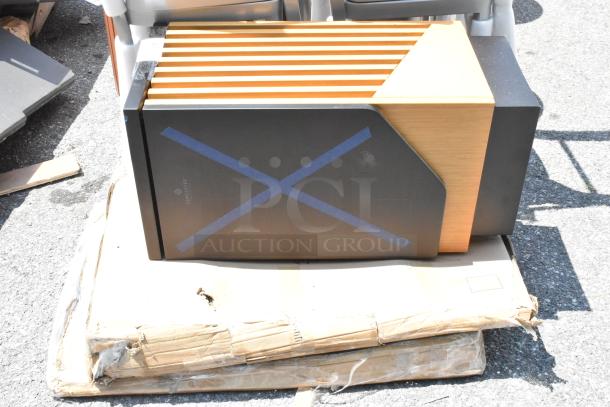 Lancaster Table & Seating metal and wood pattern trash can shell on a scratched box, showing brand marking with crossed tape.