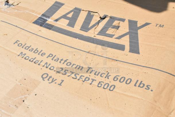 Cardboard box labeled "Lavex Foldable Platform Truck," Model No. 257SFPT600, 600 lb. capacity. Box shows some damage.