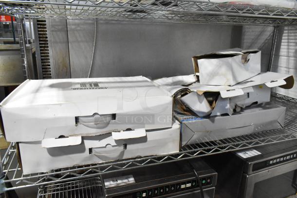 Boxes of Lorex digital surveillance equipment, including DVR and cameras, show varying wear on metal shelf.