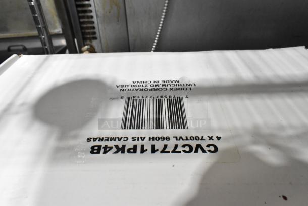 Lorex surveillance equipment lot, including digital video recorder and cameras. Box label shows model CVC7711PK4B and barcode.