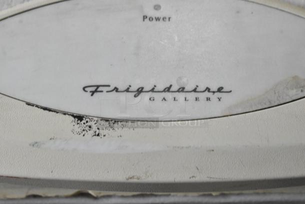 Frigidaire GLFC1526FW5 metal chest freezer, signs of wear, 115 volts, 1 phase, Frigidaire Gallery logo visible.