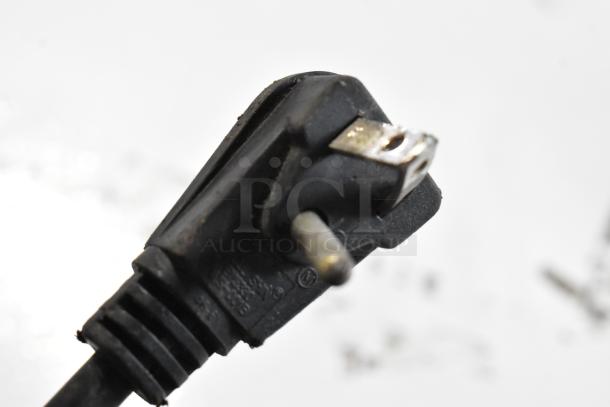 Close-up of a three-prong plug for the Frigidaire GLFC1526FW5 chest freezer, showing wear.