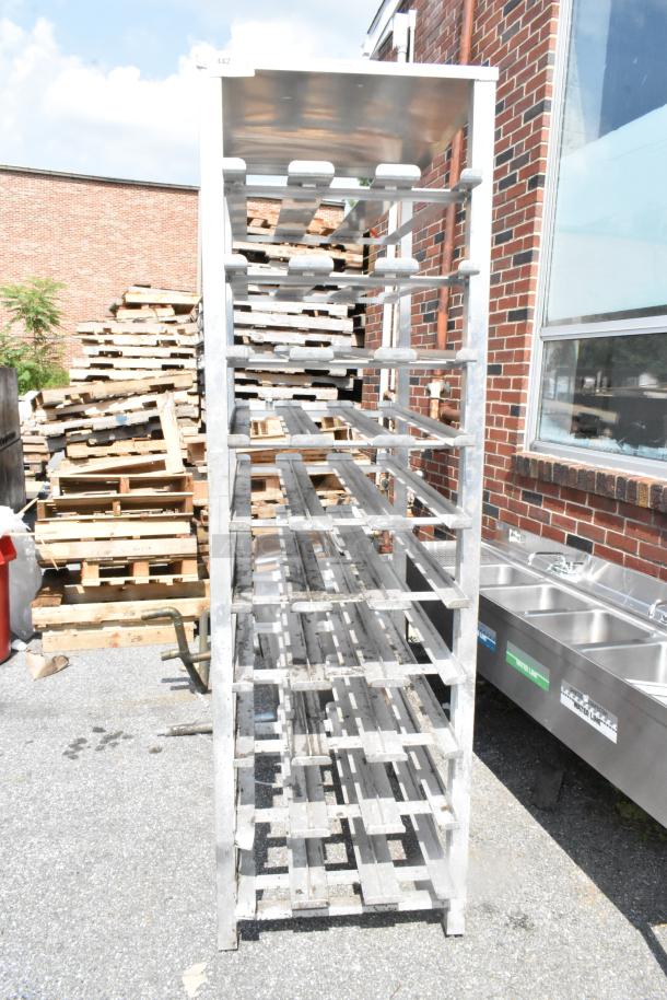Servolift Eastern metal #10 can rack in used condition, sturdy metal construction, multiple shelves for storage, outdoors.