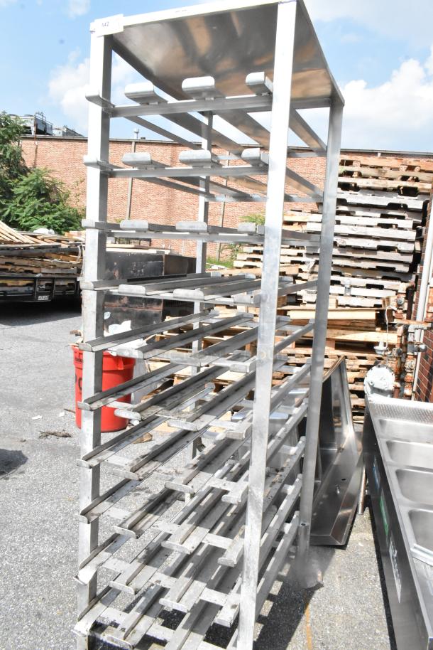 Servolift Eastern Metal #10 Can Rack, sturdy metal construction, multiple shelves, used condition, outdoor setting.