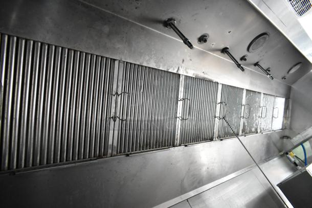 Stainless steel hood and ventilation system in a fully outfitted food trailer, ready for opening day operations.