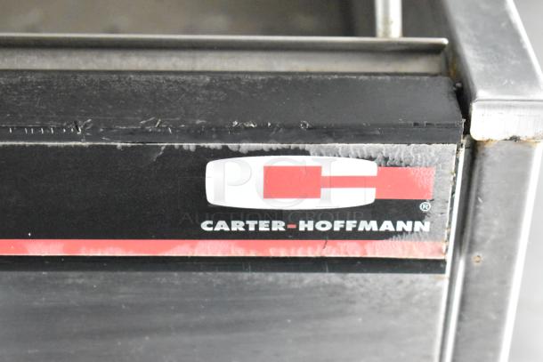 Carter-Hoffmann appliance, black with red and white logo detail, part of a fully outfitted food trailer ready for use.