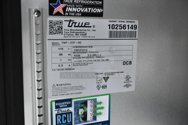 True Refrigeration label on food trailer appliance. Model TWT-27F-HC, 115V, R290 refrigerant, serial 10256149, NSF/ANSI certified.