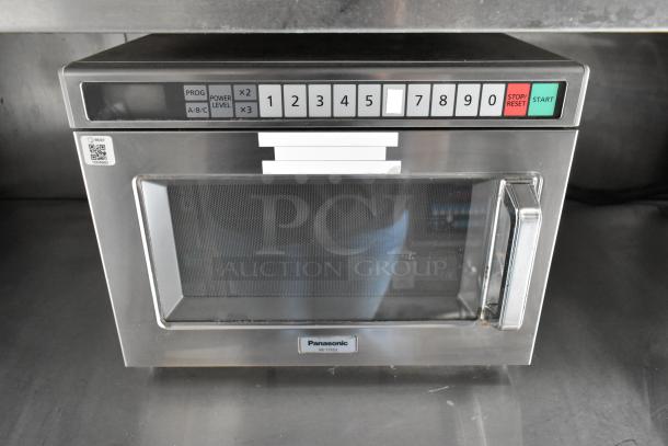 Panasonic NE-17523 commercial microwave in stainless steel with keypad controls, clean and ready for use.