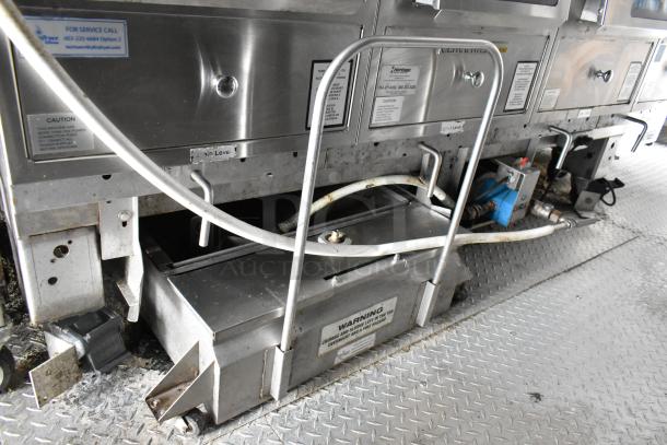 Food trailer interior with stainless steel appliances, visible service tags, and utility connections. Ready for use.