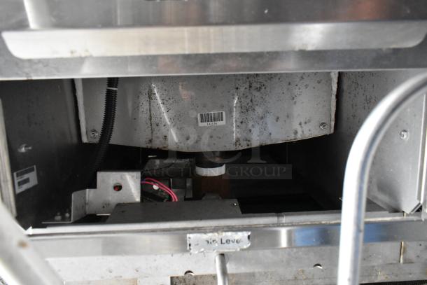 Food trailer interior showing metal fixtures and wiring, partially rusted, with barcode label reading “141136”.
