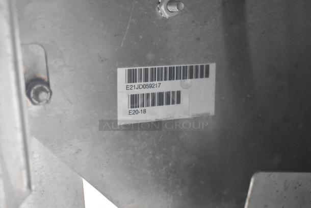 Barcode label on the interior metal surface of a food trailer. Codes read: E21JD059217 and E20-18.