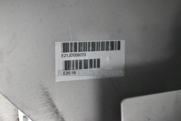 Barcode label on a fully outfitted food trailer. Code: E21JD059223, E20-18. Ideal for opening day setup.