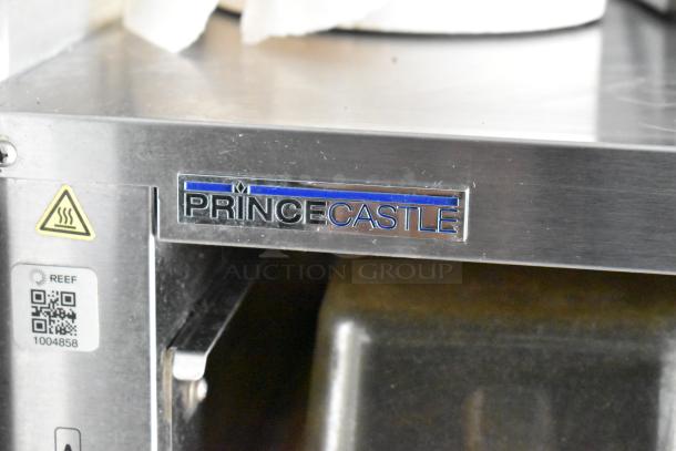 Prince Castle appliance tag on food trailer equipment, stainless steel finish, warning sign, REEF QR code 1004858.